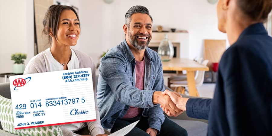 A young couple handshaking a deal with a professional. At the bottom left, a sample AAA membership card.