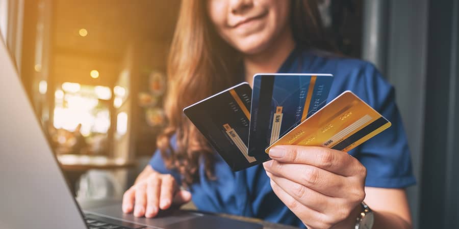 A woman holding numerous credit cards.