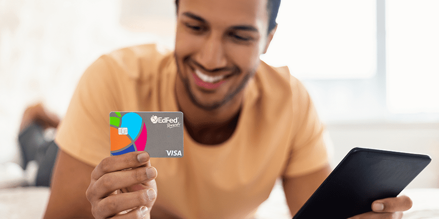 A man holding the EdFed Visa credit card.