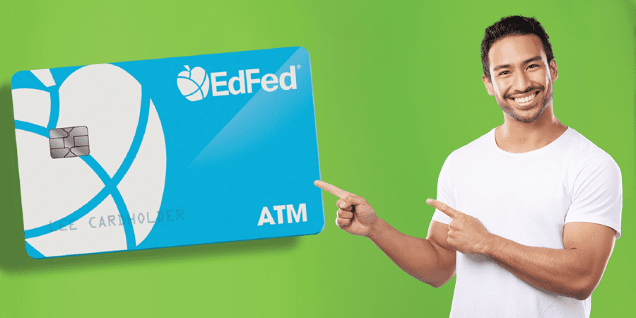 A man with a big smile pointing at an oversized EdFed ATM Card.