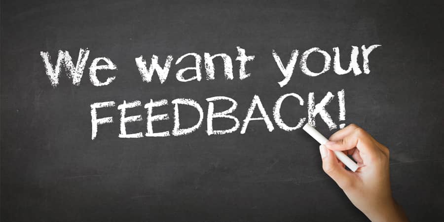 A chalkboard with the words: We want your feedback.