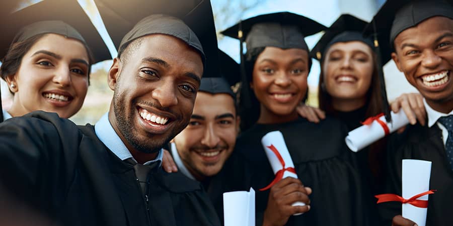 A group of graduates taking a selfie.