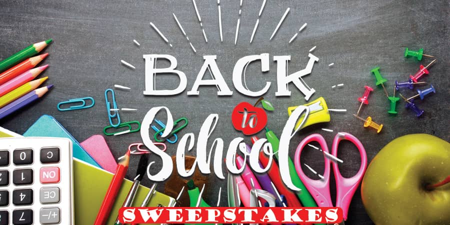 Various school supplies spread over a desk. In the center, the words: Back to school sweepstakes.