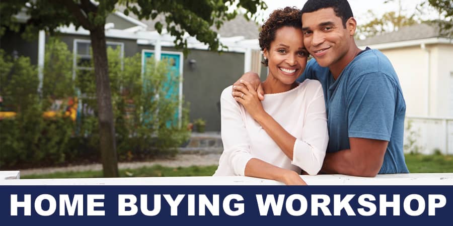 A husband and wife standing outside of their house embracing each other.