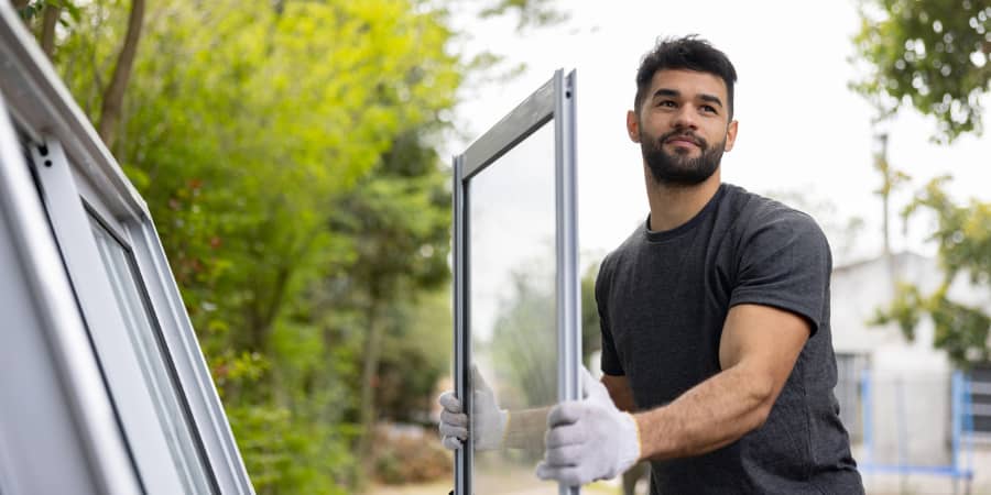 A man installing a home window.