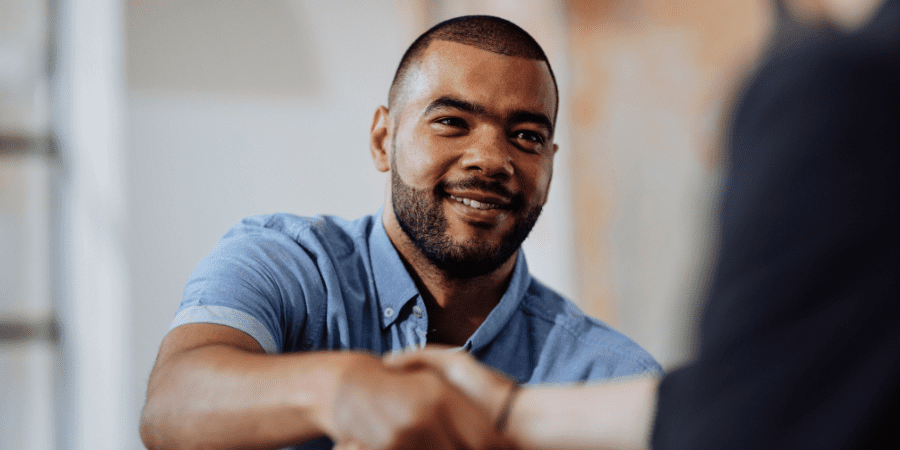 A young man shaking hands.